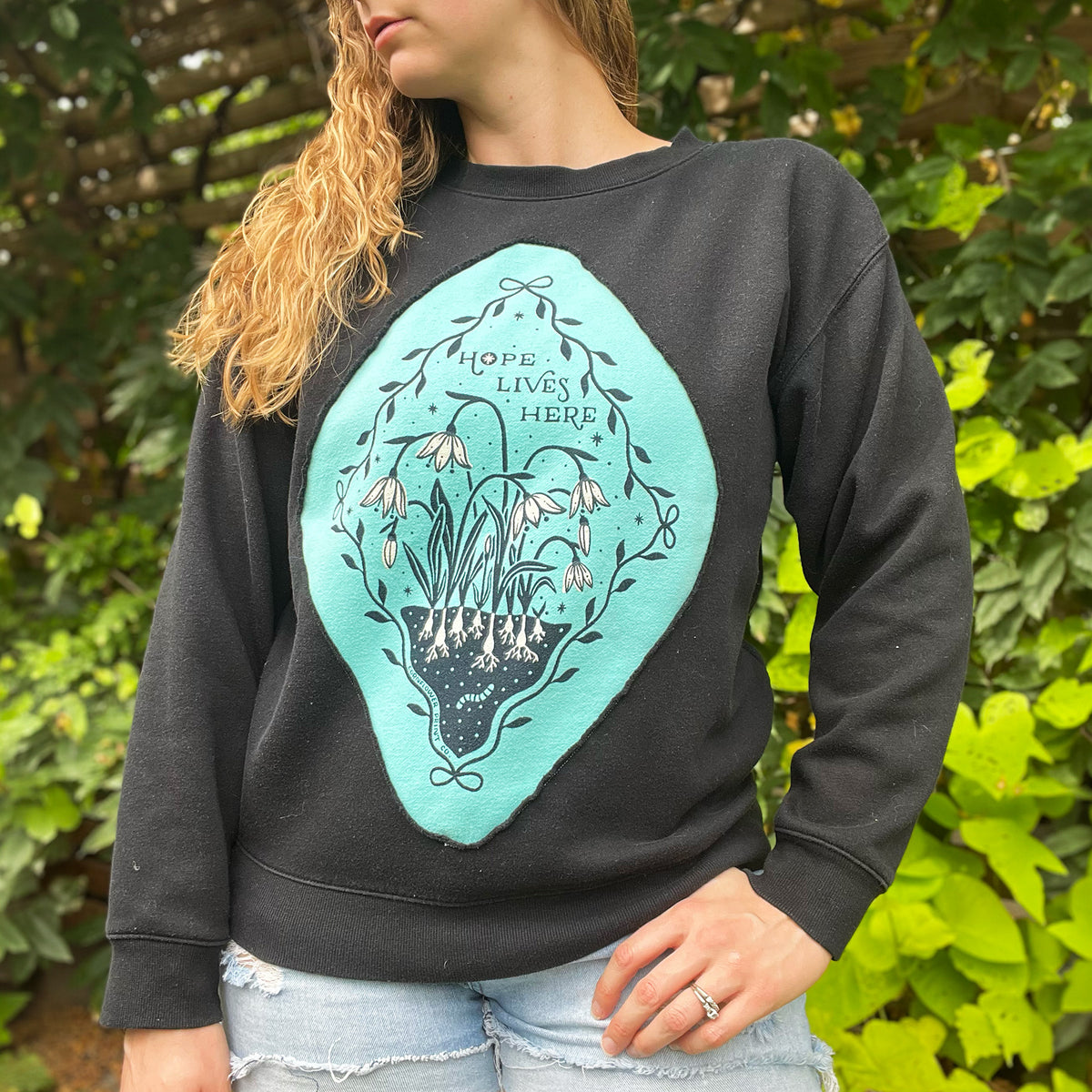 Hope Lives Here | Snow Drops | January Birth Flower | Black Sweater | Medium