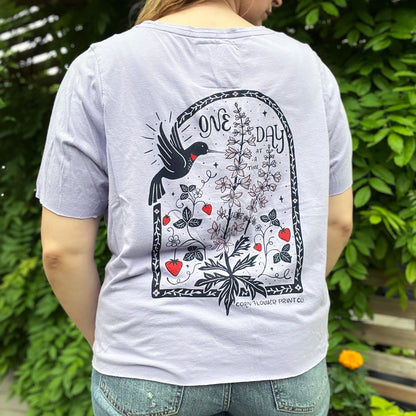 One Day at a Time | July Birth Flower | Purple Cut Off Tee w Front Pocket | XL