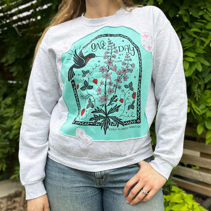 One Day at a Time | July Birth Flower | Gray / Blue Reverse Applique Pullover Sweatshirt | Medium