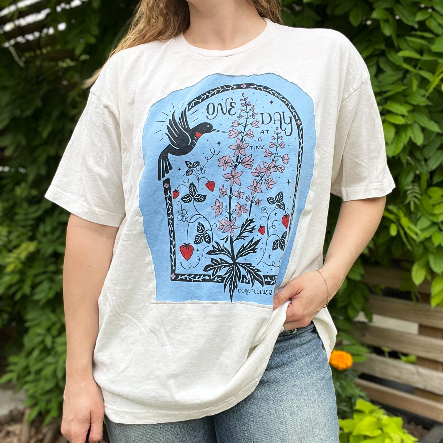 One Day at a Time | July Birth Flower | Off-White Tee w Blue Reverse Applique Tee | 2X